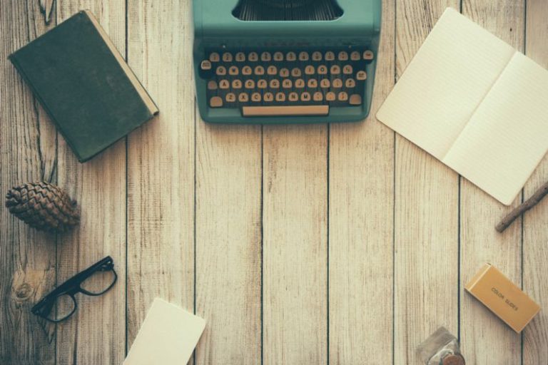 Life Hacks - vintage teal typewriter beside book