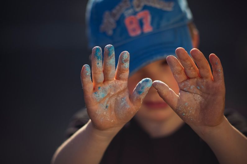 Child Creativity - person in blue and white shirt covering face with hands