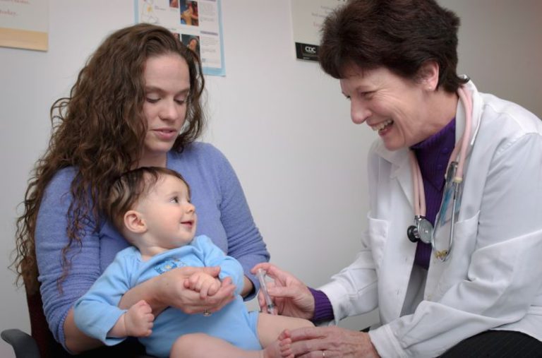 Pediatrician - a young child is being examined by a doctor