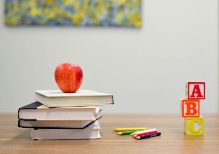 First Day Of School - red apple fruit on four pyle books