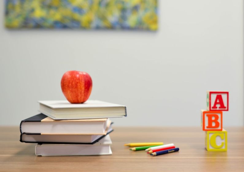 First Day Of School - red apple fruit on four pyle books