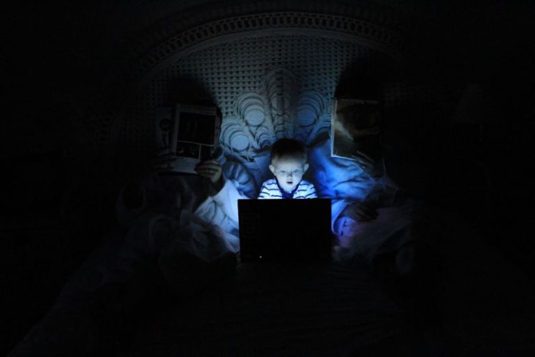Internet Safety - boy playing at laptop inside room