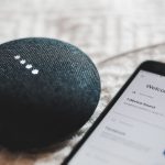 Smart Home - turned-on charcoal Google Home Mini and smartphone