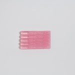 Plastic Reduction - three pink toothbrushes on a white surface