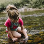 Kids Nature - girl playing on body of water