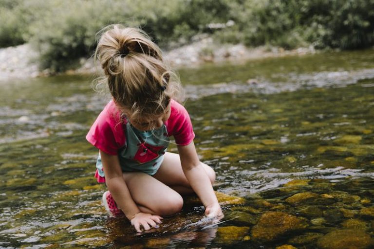 Kids Nature - girl playing on body of water