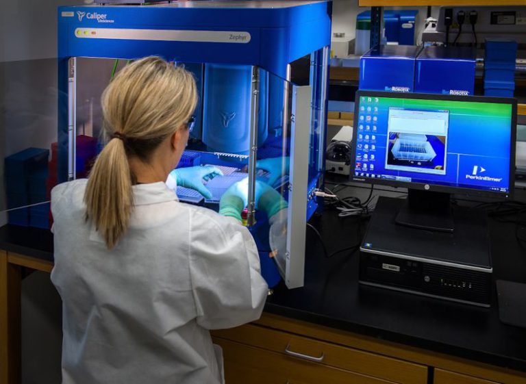 Healthcare Tech - woman in white shirt standing in front of computer