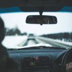 Winter Driving - man inside car near trees at daytime