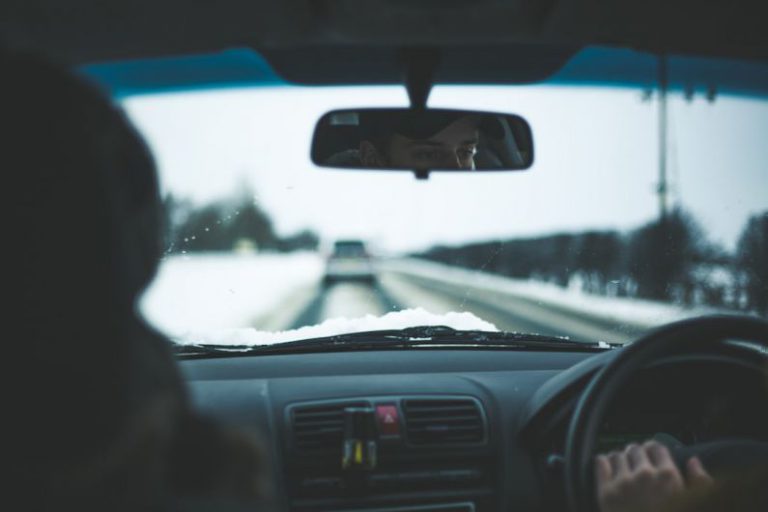 Winter Driving - man inside car near trees at daytime