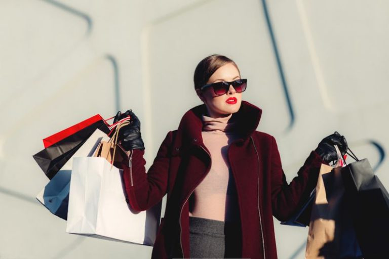 Online Shopping - photo of woman holding white and black paper bags