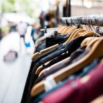 Secondhand Shopping - selective focus photography of hanged clothes