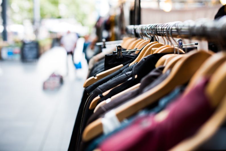 Secondhand Shopping - selective focus photography of hanged clothes
