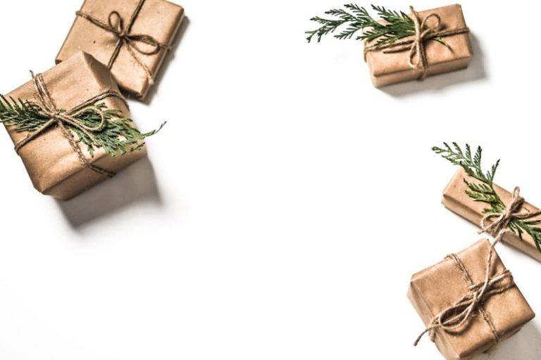 Seasonal Sale - four brown gift boxes on white surface