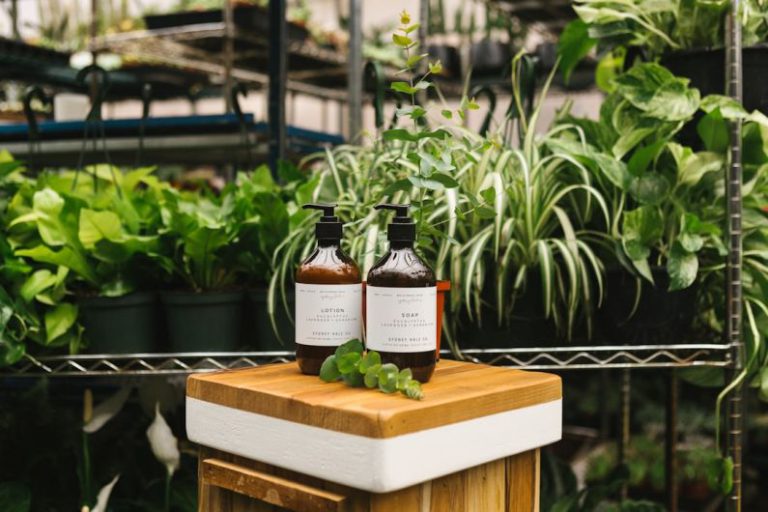Green Products - two amber glass pump bottles on top of wooden table