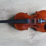 Music Instrument - brown violin on white textile