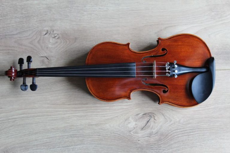 Music Instrument - brown violin on white textile
