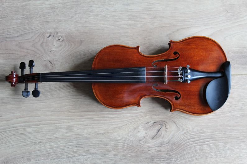 Music Instrument - brown violin on white textile