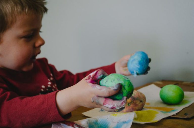 Art Project - boy holding blue and green painted egg shells