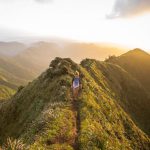 Hiking Beginners - woman walking on pathway on top of hill at golden hour