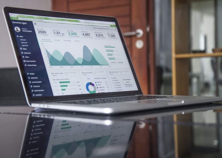 AI Finance - laptop computer on glass-top table