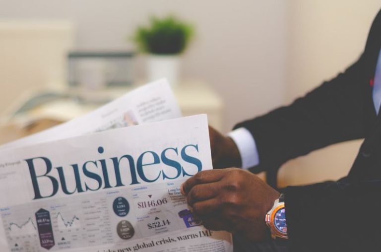Personal Finance Planning - person wearing suit reading business newspaper