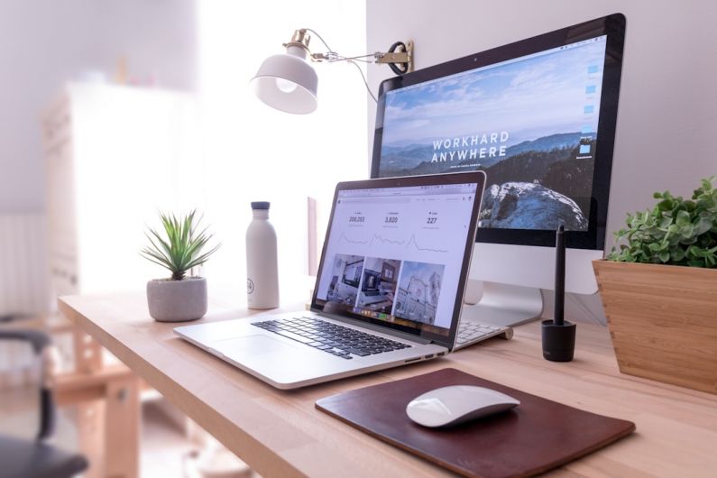 Office Organization - MacBook Pro on table beside white iMac and Magic Mouse