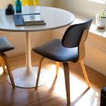 DIY Home Office - round white dining table beside two chairs on brown hardwood flooring