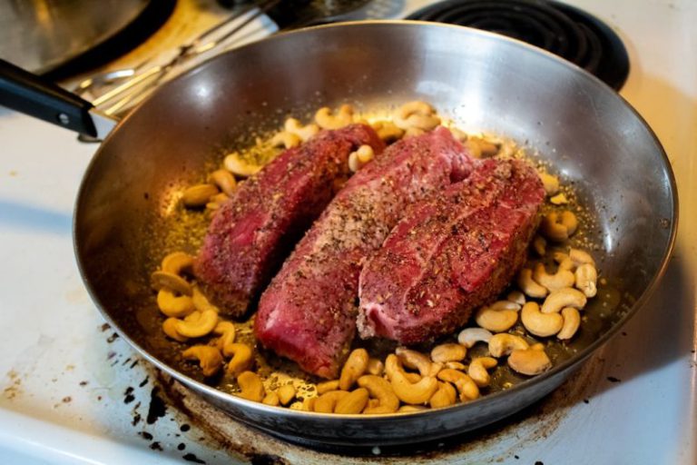 Cooking Steak - cooked meat on stainless steel bowl