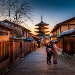 Solo Female Travel - two women in purple and pink kimono standing on street