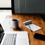 Job Skills - MacBook Pro, white ceramic mug,and black smartphone on table