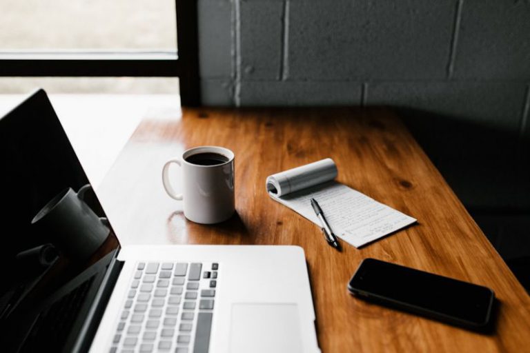 Job Skills - MacBook Pro, white ceramic mug,and black smartphone on table