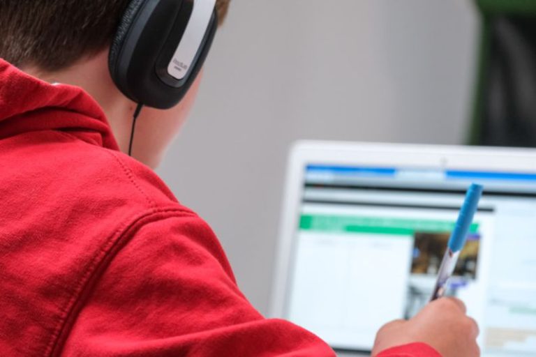 Online Learning - person in red shirt wearing black and gray headphones