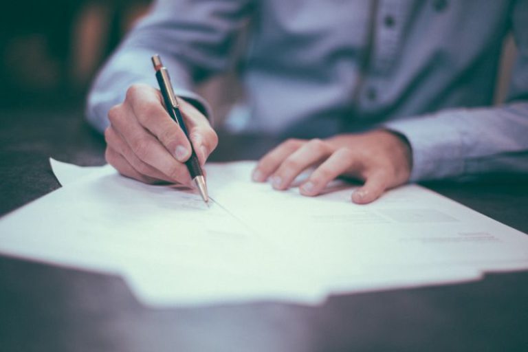 Work Satisfaction - man writing on paper