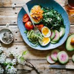 Healthy Kids Meal - poached egg with vegetables and tomatoes on blue plate