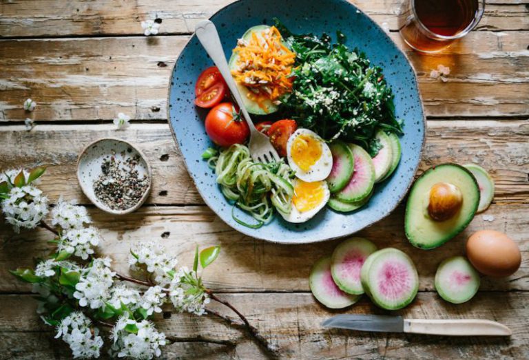 Healthy Kids Meal - poached egg with vegetables and tomatoes on blue plate