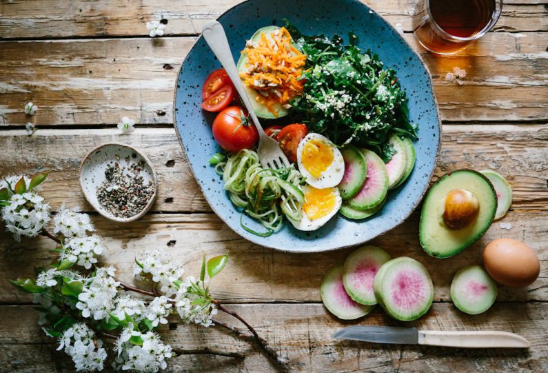 Healthy Kids Meal - poached egg with vegetables and tomatoes on blue plate